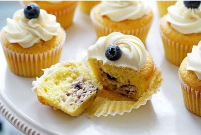 Thumbnail for Blueberry Cheesecake-Stuffed Lemon Cupcakes With Vanilla Frosting
