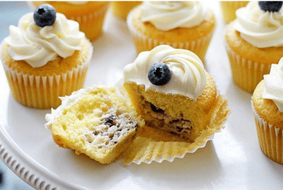 Thumbnail for Blueberry Cheesecake-Stuffed Lemon Cupcakes With Vanilla Frosting